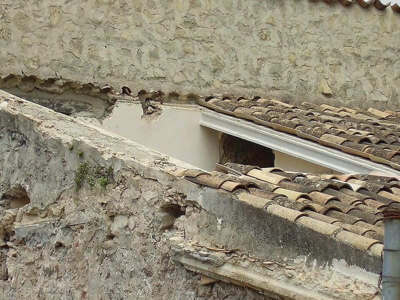 After tile restoration showing newly restored Spanish barrel tile roof with crisp lines, fresh mortar pointing, and renewed luster